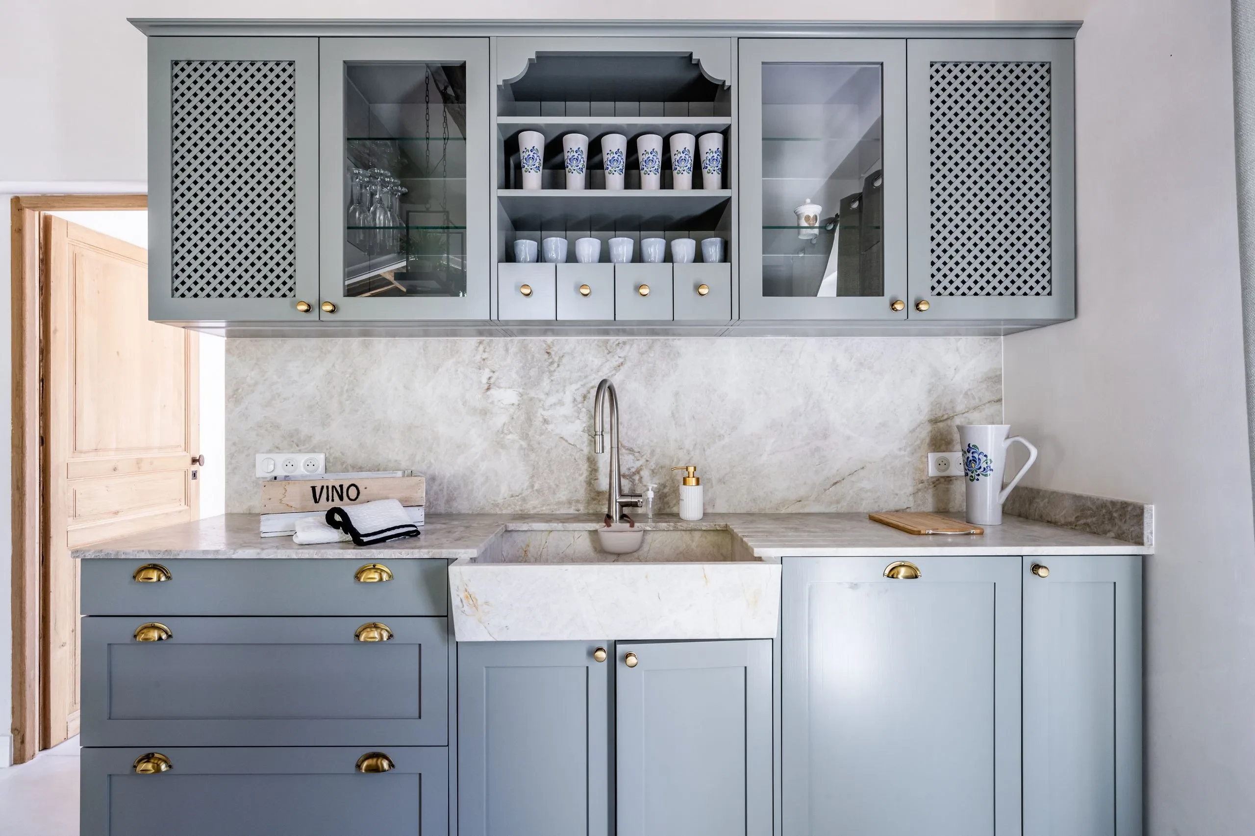 Cuisine moderne avec placards gris et évier en marbre.